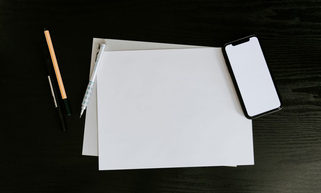 white printer paper on black table